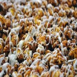 Yum Yum's Gourmet Popcorn - Chocolate Swirl Popcorn, A delicious Chocolate covered popcorn hand drizzled with melt on white caramel. It is a wonderful delig