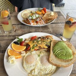 Chilaquiles and two eggs over easy with side of avocado and Hollywood hashbrowns Chilaquiles and two eggs over easy with side of avocado and Hollywood hashbrowns