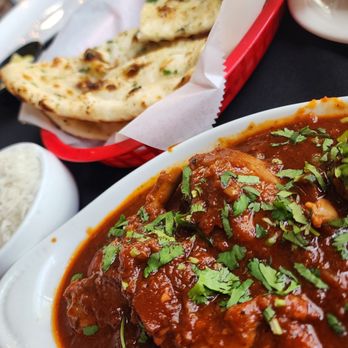 Spice & Saga - I forget the name of this dish. It was chicken. Steamed rice and a garlic flat bread type dish. It was amazing. - Indian Near Me - Amarillo, Texas