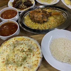 Zuzu Restaurant - Iraqi Style Mandi Shank. Chicken and vegetables in Alfredo sauce cooked in clay pot. Tomato based soups that came with mandi meal