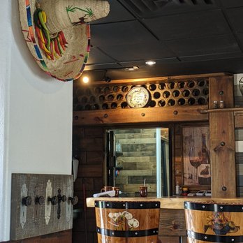 La Campana Mexican & Seafood Restaurant - a bar with a mexican hat on the wall - Mexican Near Me - Orlando, Florida
