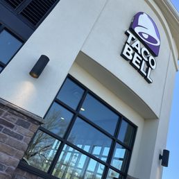 The sign of taco bell as I wait for my drive thru order in the fire lane.