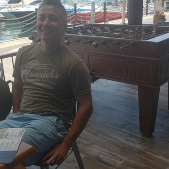 Golden Legends - My boyfriend next to the foosball table on patio (I won) - Sports Bars Near Me - Cabo San Lucas, BCS
