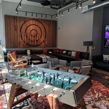 Moxy Seattle Downtown - Common area to relax, play foosball, or enjoy a cocktail from the center bar. - Hotels Near Me - Seattle, Washington Moxy Seattle Downtown - Common area to relax, play foosball, or enjoy a cocktail from the center bar. - Hotels Near Me - Seattle, Washington