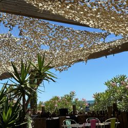 Sunrise Beach Hotel - Covered patio near the shore.