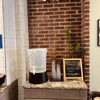 Cafe Nube - a brick wall and counter with a coffee maker - Tacos Near Me - Brooklyn, New York