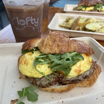 Lofty Coffee - Mocha iced latte , sausage egg and cheese croissant, & potatoes. - Coffee & Tea Near Me - San Diego, California