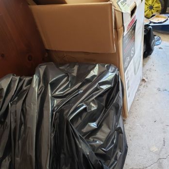 Peach Construction - a pile of boxes in a garage - General Contractors Near Me - Chula Vista, California