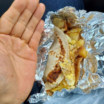 Rocha’s Bar & Grill - a hand holding a burrito - Breakfast & Brunch Near Me - Laredo, Texas Rocha’s Bar & Grill - a hand holding a burrito - Breakfast & Brunch Near Me - Laredo, Texas