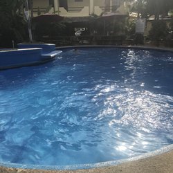 Acuario - Bean shape pool with a small shallow area on top that waterfalls into the pool.