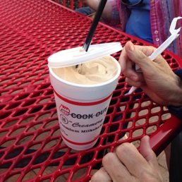 a woman eating a cup of ice cream a woman eating a cup of ice cream