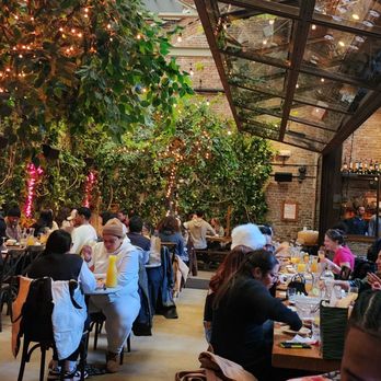 Ainslie - people sitting at tables in a restaurant - Beer Gardens Near Me - Brooklyn, New York