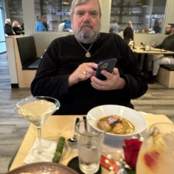 Rustica Earth Sea and Fire - Husband taking photos of his great scallop risotto dinner - Asian Fusion Near Me - St. Augustine, Florida Rustica Earth Sea and Fire - Husband taking photos of his great scallop risotto dinner - Asian Fusion Near Me - St. Augustine, Florida