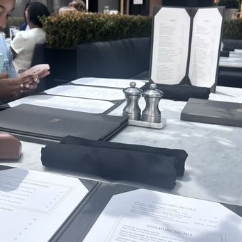 RH Rooftop Restaurant at RH Charlotte - looking at the menu our table very aesthetic - American Near Me - Charlotte, North Carolina