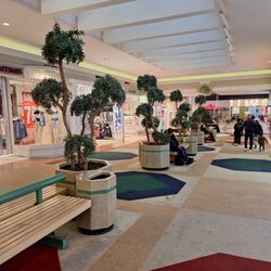 Place Versailles - Carpeted walkways, planters, sloped floor changes, and the overall vibe speak to a Place Versailles from the '70s.