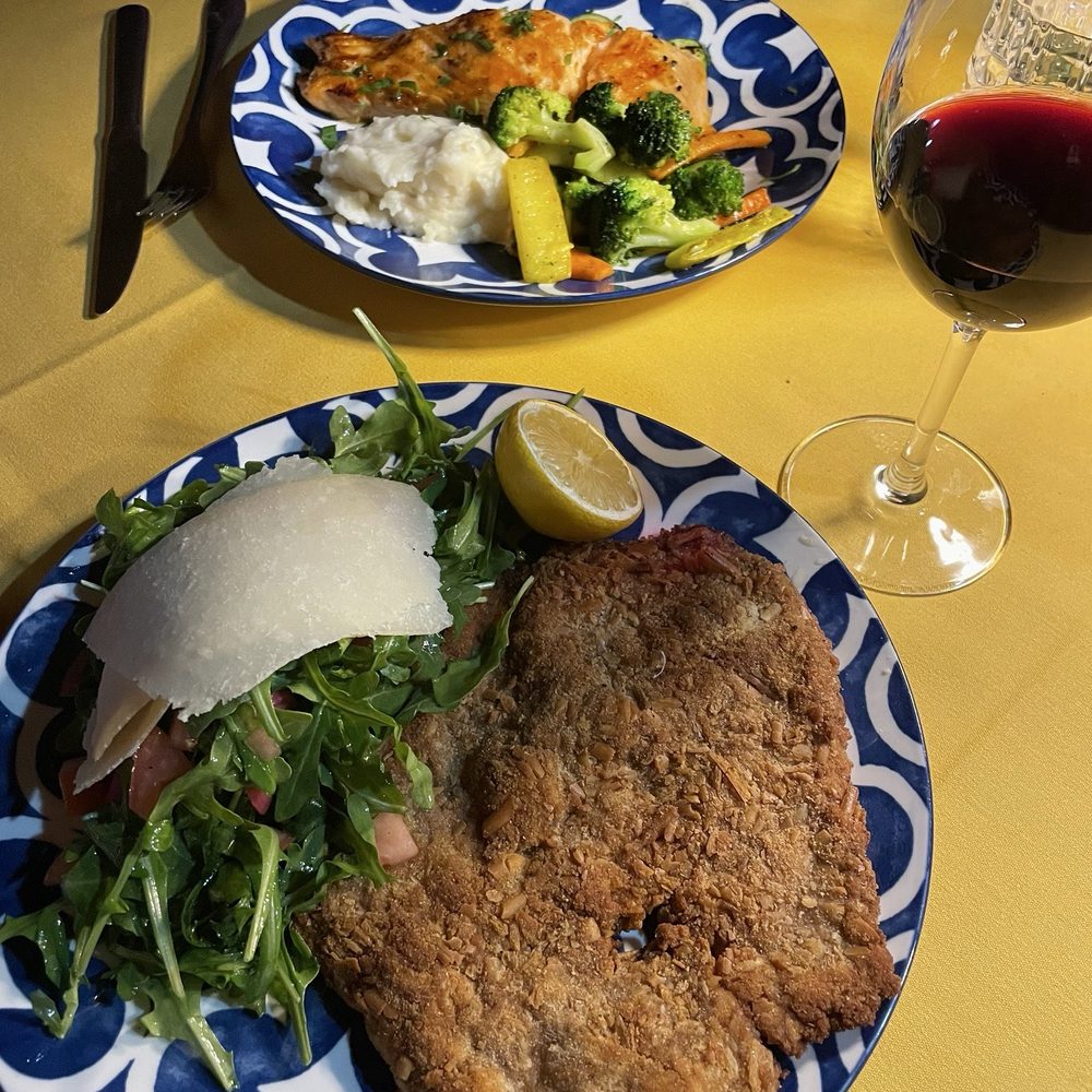 Caffe Milano - Grilled salmon with great sides of mashed potatoes and grilled vegetables (top); veal Milano with an excellent arugula salad accompaniment. - Italian Near Me - North Kingstown, Rhode Island
