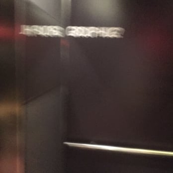 Hotel Max - Blurry photo of the cheeky elevator signage saying "Group Hug?" - Hotels Near Me - Seattle, Washington
