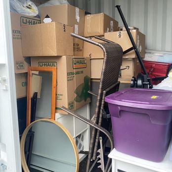 Cast Iron Moving - Chair on its side puncturing other furniture, mirrors not covered, boxes inaccessible as they are stacked nearly 10' high in the back. - Movers Near Me