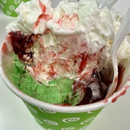 Three kinds of ice cream ( pistachio, tres leches and cappuccino) with strawberry topping, whipped cream and cherries. Three kinds of ice cream ( pistachio, tres leches and cappuccino) with strawberry topping, whipped cream and cherries.