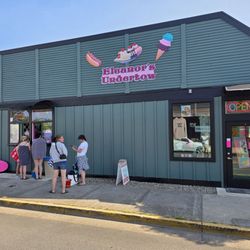 Northwest corner of the ice cream shop and covered walk-up window, and entrance to interior.