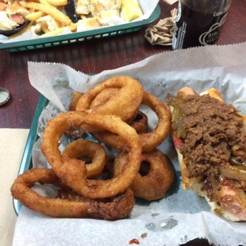 Dogtown - Pit Bull with onion rings. The Pit Bull is a zweigles red hot with hot sauce, BBQ sauce and peppers and onions. - American Near Me - Rochester, New York Dogtown - Pit Bull with onion rings. The Pit Bull is a zweigles red hot with hot sauce, BBQ sauce and peppers and onions. - American Near Me - Rochester, New York