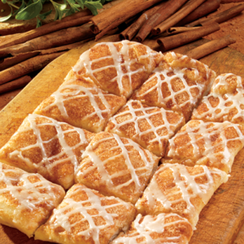 Marco's Pizza - a wooden cutting board with cinnamon rolls and cinnamon sticks - Pizza Near Me - Junction City, Kansas