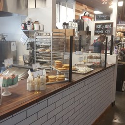 a bakery counter with a variety of baked goods