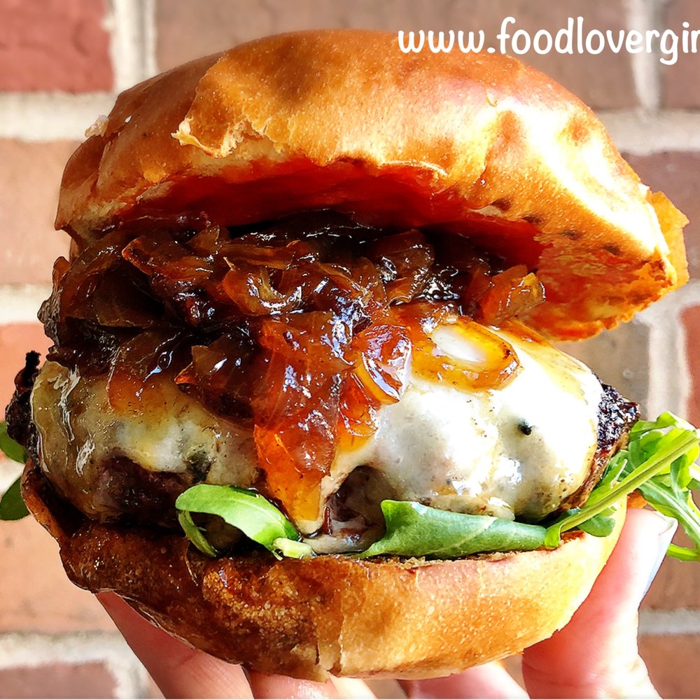 Trevi Cafe & Wine Bar - a hand holding a burger - Wine Bars Near Me - Mashpee, Massachusetts Trevi Cafe & Wine Bar - a hand holding a burger - Wine Bars Near Me - Mashpee, Massachusetts