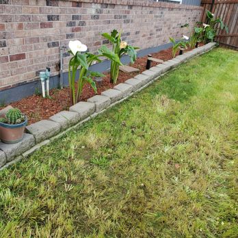 4 Seasons Gardening - a flower bed in front of a brick wall - Gardeners Near Me 4 Seasons Gardening - a flower bed in front of a brick wall - Gardeners Near Me