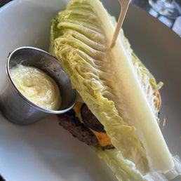 Truffle Crunch Burger on a lettuce bun with truffle aioli, American cheese, roasted mushrooms, provolone cheese, house chips. Truffle Crunch Burger on a lettuce bun with truffle aioli, American cheese, roasted mushrooms, provolone cheese, house chips.