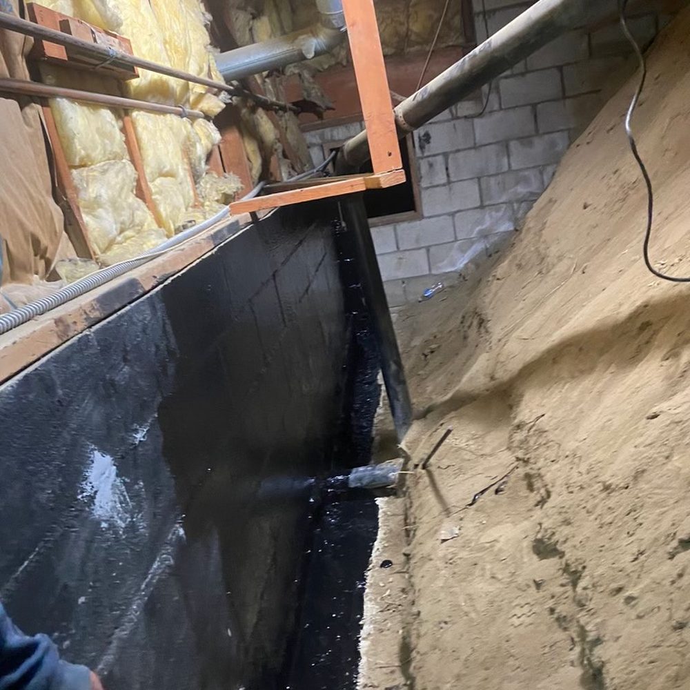 They drilled down a few feet and waterproofed the wall adjacent to basement bedroom