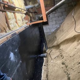 They drilled down a few feet and waterproofed the wall adjacent to basement bedroom They drilled down a few feet and waterproofed the wall adjacent to basement bedroom