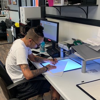Elysium Ink Body Art - Zay sketching a tattoo - Piercing Near Me - Concord, North Carolina