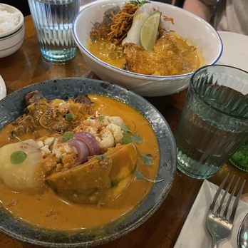Soothr - Back: Chicken Khao Soi, Front: stewed beef Massaman curry - Thai Near Me - New York, New York