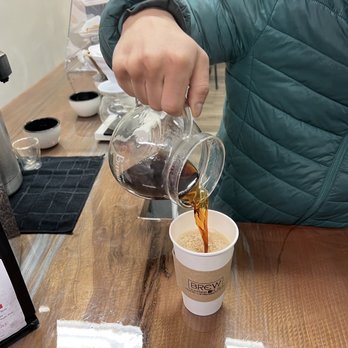 Brew Coffee Bar - a person pouring a cup of coffee - Coffee & Tea Near Me - Matawan, New Jersey