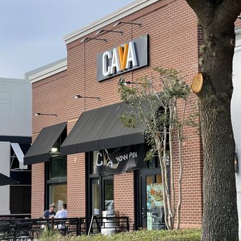 CAVA - the outside of a restaurant with tables and umbrellas - Salad Near Me - Mount Pleasant, South Carolina