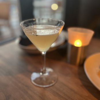 Ecco Midtown - a glass of champagne sitting on a table - Modern European Near Me - Atlanta, Georgia Ecco Midtown - a glass of champagne sitting on a table - Modern European Near Me - Atlanta, Georgia