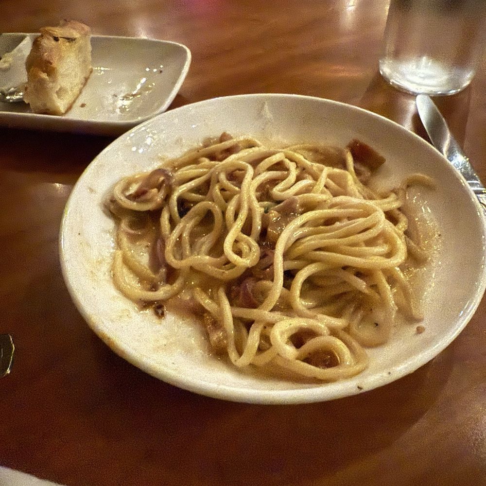 Capers + Olives - Bucatini carbonara type with focaccia in the background. - Italian Near Me - Everett, Washington