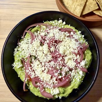 Mala Pata Molino + Cocina - Fresh Guacamole - With Marinated Tomatoes, Cotija Cheese, Pickled Onions, Pepitas, and Cilantro, served with House-Made Corn Chips. - Mexican Near Me - Raleigh, North Carolina Mala Pata Molino + Cocina - Fresh Guacamole - With Marinated Tomatoes, Cotija Cheese, Pickled Onions, Pepitas, and Cilantro, served with House-Made Corn Chips. - Mexican Near Me - Raleigh, North Carolina