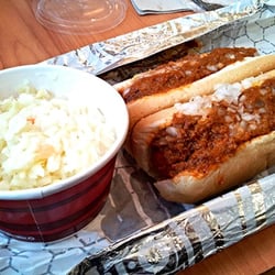 Two chili cheese dogs with side of slaw.
