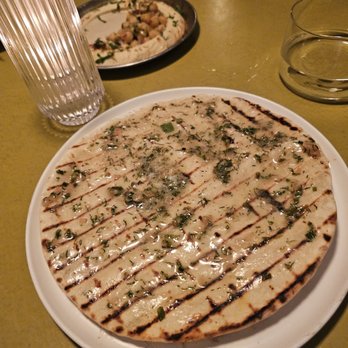 Shukette - Laffa- Grilled flatbread topped with preserved lemon butter, dill, sumac, and sea salt. $12. A bit messy, but tasty - Middle Eastern Near Me - New York, New York