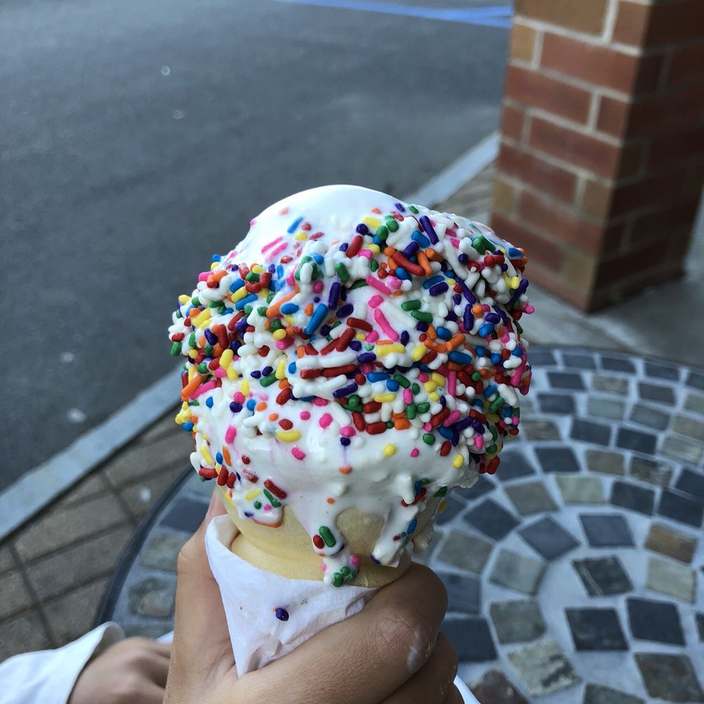 Corner Ice Cream Store - a person holding an ice cream cone with sprinkles - Ice Cream & Frozen Yogurt Near Me - Schenectady, New York Corner Ice Cream Store - a person holding an ice cream cone with sprinkles - Ice Cream & Frozen Yogurt Near Me - Schenectady, New York
