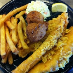 Three pieces of fish, cole slaw, and fries