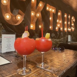 two cocktails on a wooden table two cocktails on a wooden table