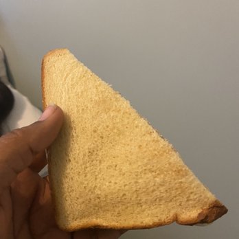 Brooklyn Barista - a hand holding a slice of bread - Coffee & Tea Near Me - New York, New York Brooklyn Barista - a hand holding a slice of bread - Coffee & Tea Near Me - New York, New York