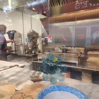 Duck Donuts - Worker dropping the dough into the machine - Donuts Near Me - Las Vegas, Nevada Duck Donuts - Worker dropping the dough into the machine - Donuts Near Me - Las Vegas, Nevada