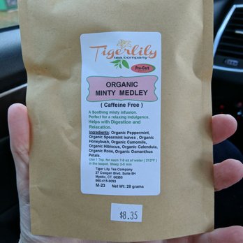 Tiger Lily Tea - a hand holding a bag of tea - Tea Rooms Near Me - Mystic, Connecticut