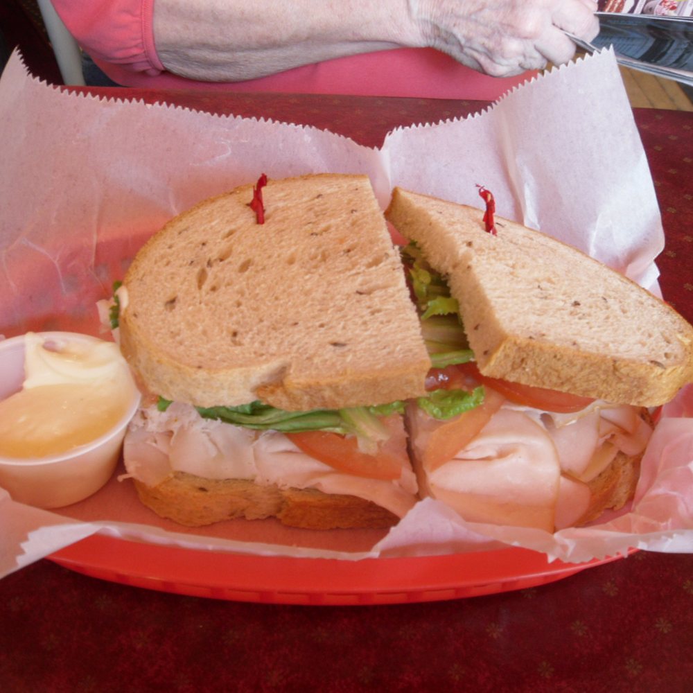 Schnitz Deli - "Mary's Dilemma" - Smoked turkey breast, Dutch Edam cheese, lettuce, tomato, & mayo on rye. - Delis Near Me - Grand Rapids, Michigan Schnitz Deli - "Mary's Dilemma" - Smoked turkey breast, Dutch Edam cheese, lettuce, tomato, & mayo on rye. - Delis Near Me - Grand Rapids, Michigan