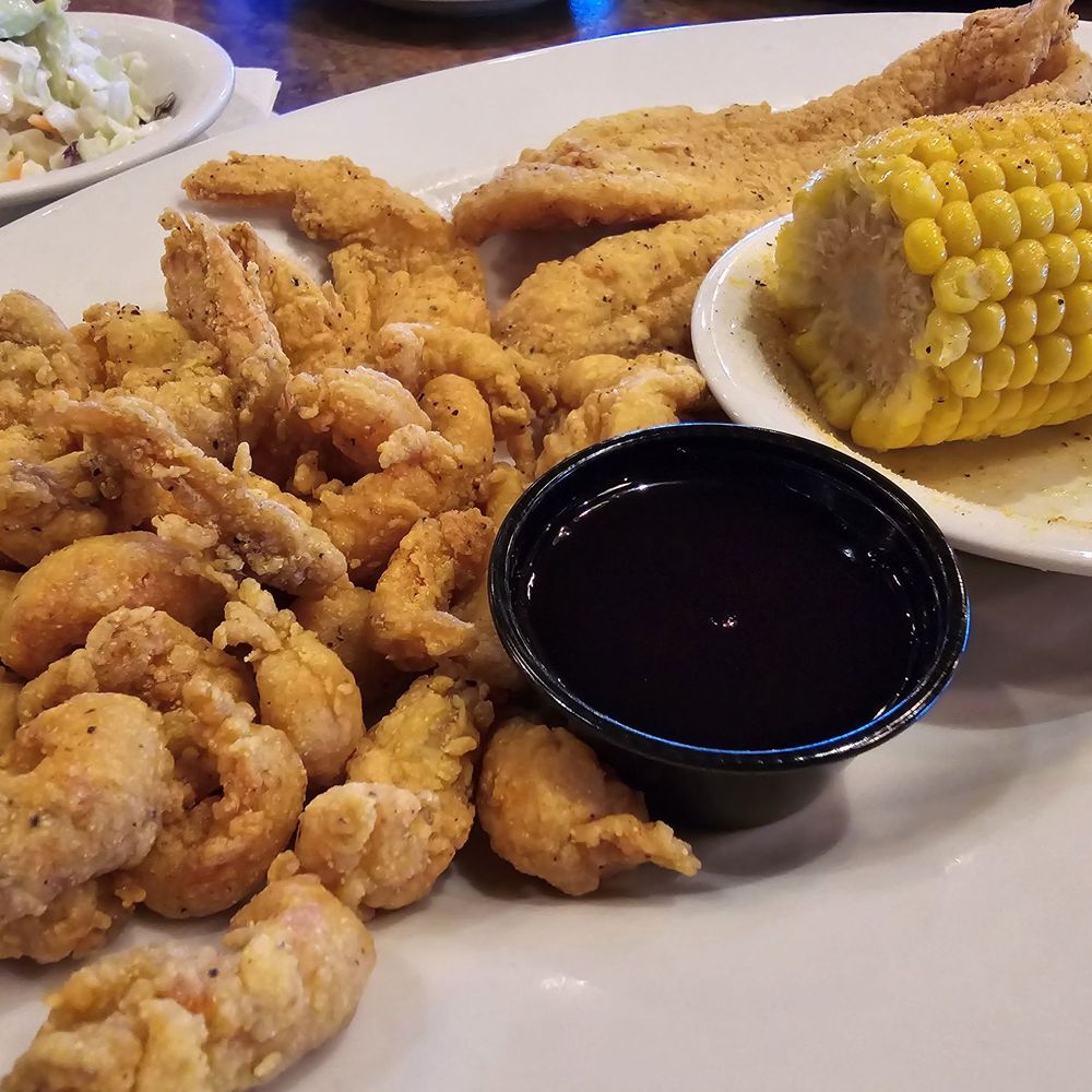Razzoo's Cajun Cafe - SEAFOOD COMBO PLATTER, which included hand-battered fried shrimp, two small fish filets and crawfish tails. - Cajun/Creole Near Me - Irving, Texas Razzoo's Cajun Cafe - SEAFOOD COMBO PLATTER, which included hand-battered fried shrimp, two small fish filets and crawfish tails. - Cajun/Creole Near Me - Irving, Texas