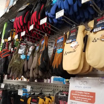 Welden Hardware - Store pegboard with various work gloves, oven mitts, and a fireplace tool set, labeled with prices and tags. - Hardware Stores Near Me - Simsbury, Connecticut